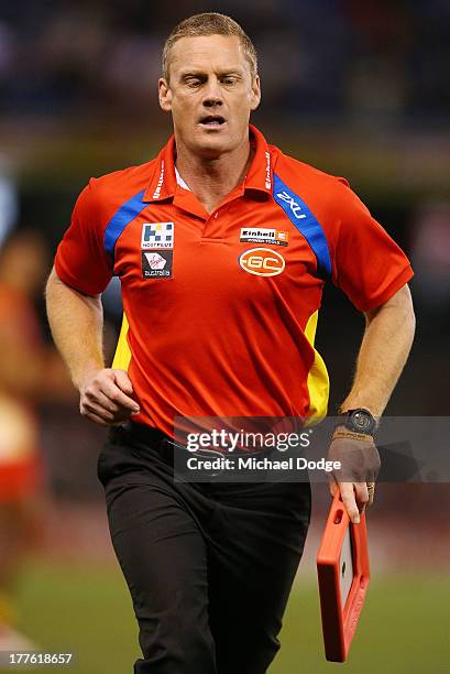 Suns coach Guy Mckenna runs off the ground during the round 22 AFL match between the St Kilda Saints and the Gold Coast Suns at Etihad Stadium on...