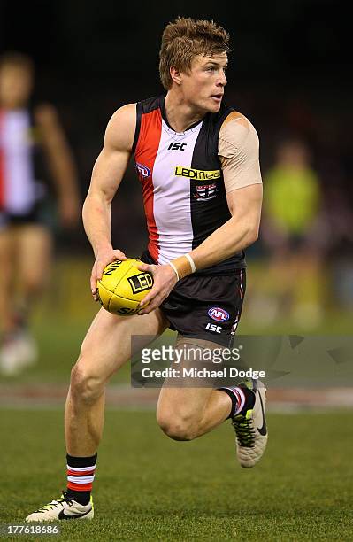 Jack Newnes of the Saints runs with the ball during the round 22 AFL match between the St Kilda Saints and the Gold Coast Suns at Etihad Stadium on...