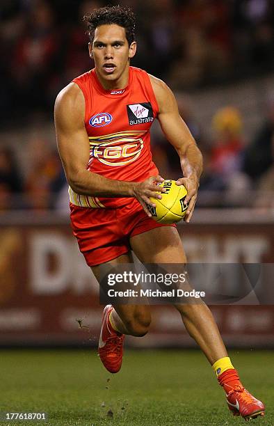 Harley Bennell of the Suns runs with the ball during the round 22 AFL match between the St Kilda Saints and the Gold Coast Suns at Etihad Stadium on...