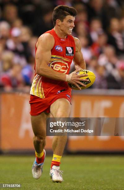 Jaeger O'Meara of the Suns runs with the ball during the round 22 AFL match between the St Kilda Saints and the Gold Coast Suns at Etihad Stadium on...