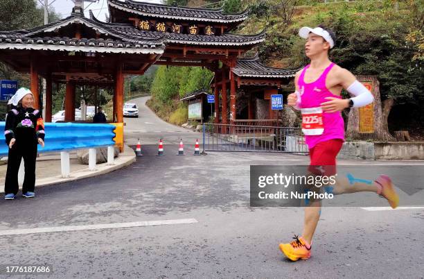 Participants run during the 2023 Guizhou Ring Leigong Mountain Marathon in Leishan county, Qiandongnan, Guizhou Province, China, Nov 11, 2023.