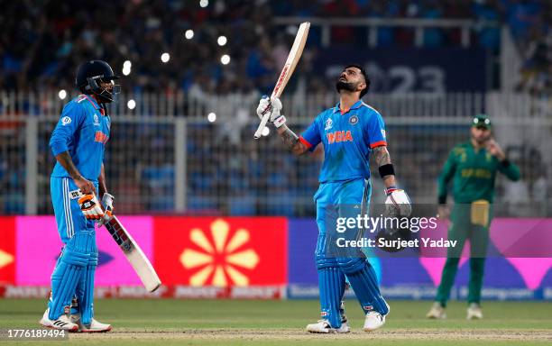 Virat Kohli of India celebrates their century with team mate Ravi Jadeja to equal Sachin Tendulkar's record for most ODI centuries for India during...