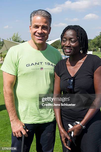 Auma Obama and Karsten Speck take part in the 6th GRK Golf Charity Masters at Golf & Country Club Leipzig on August 24, 2013 in Leipzig, Germany.