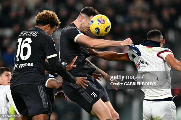 Juventus' Italian defender Federico Gatti heads the ball during the Italian Serie A football match between Juventus and Cagliari, at The Allianz...