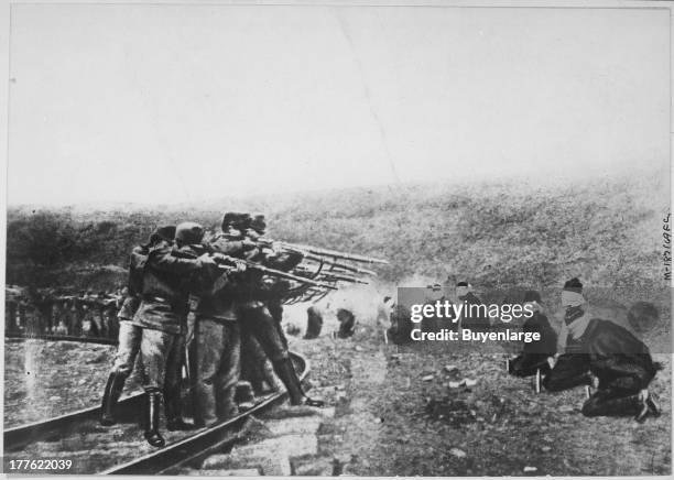 View showing an example of Austria's atrocities depicts patriotic Jugo-Slavs in Serbia, blindfolded and in a kneeling position, arranged in a...