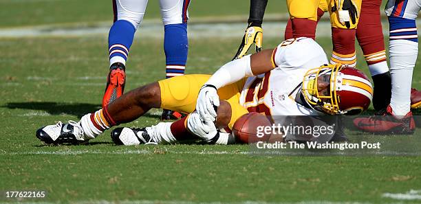 August 24: Washington Redskins punt returner Richard Crawford grabs his left knee after he is hit by Buffalo Bills outside linebacker Arthur Moats...