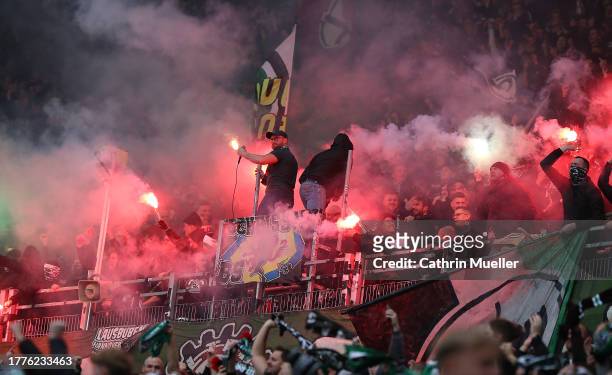 Fans of Hannover 96 burning flares during the Second Bundesliga match between Hannover 96 and Eintracht Braunschweig at Heinz von Heiden Arena on...