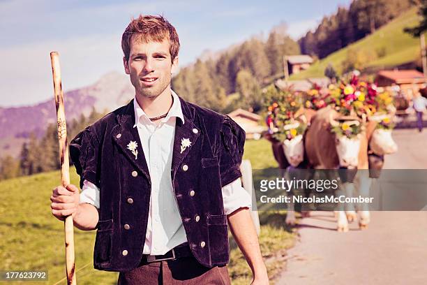 swiss farmer leading decorated cows to aelplerfest - swiss cow stock pictures, royalty-free photos & images