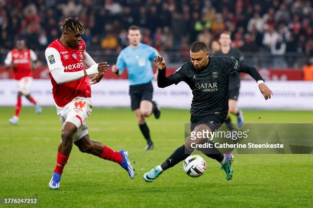 Kylian Mbappe of Paris Saint-Germain controls the ball against Emmanuel Agbadou of Stade de Reims during the Ligue 1 Uber Eats match between Stade de...