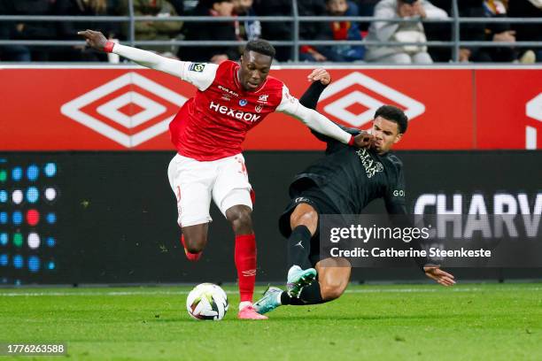 Mohamed Daramy of Stade de Reims challenges Warren Zaire Emery of Paris Saint-Germain during the Ligue 1 Uber Eats match between Stade de Reims and...