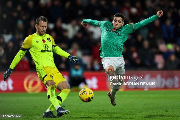 Newcastle United's English striker Ben Parkinson jumps to stop a shot by Bournemouth's Brazilian goalkeeper Neto during the English Premier League...