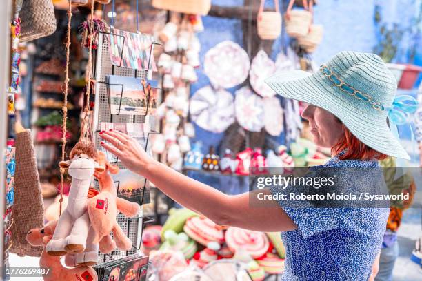charming woman shopping in a street market - momentos stock pictures, royalty-free photos & images