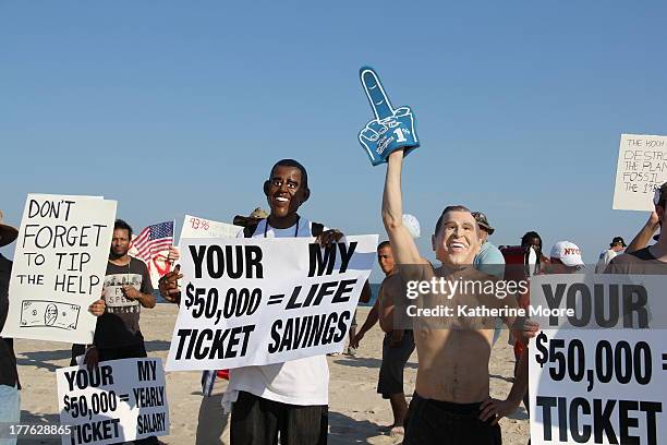 Protesters gather at Coopers beach, in between the ocean and the home of David Koch which was guarded by police and Secret Service agents. The...