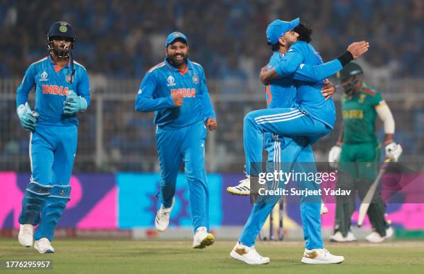 Ravi Jadeja of India celebrates the wicket of Temba Bavuma of South Africa with team mate Virat Kohli during the ICC Men's Cricket World Cup India...