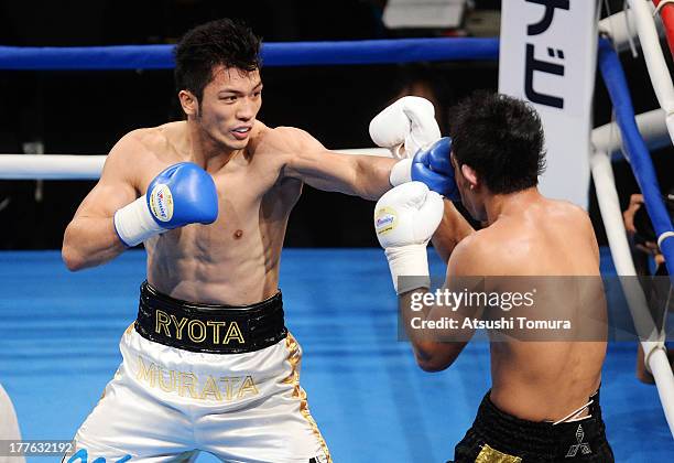 Ryota Murata of Japan punches Akio Shibata of Japan during his debut match as professional boxer against Akio Shibata at Ariake Colosseum on August...