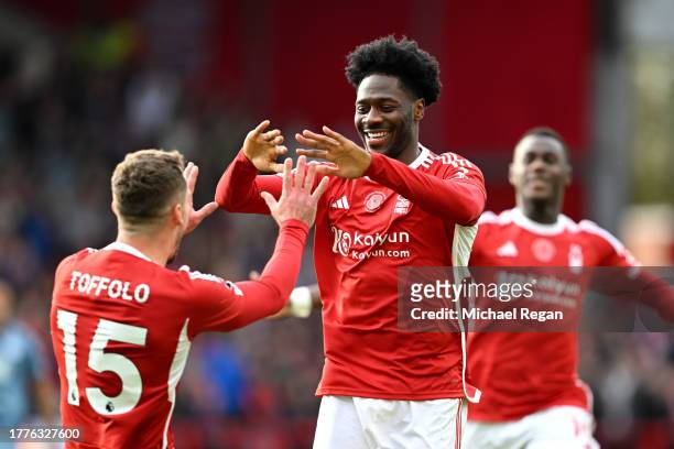 Ola Aina of Nottingham Forest celebrates with Harry Toffolo of Nottingham Forest after scoring the team's first goal during the Premier League match...