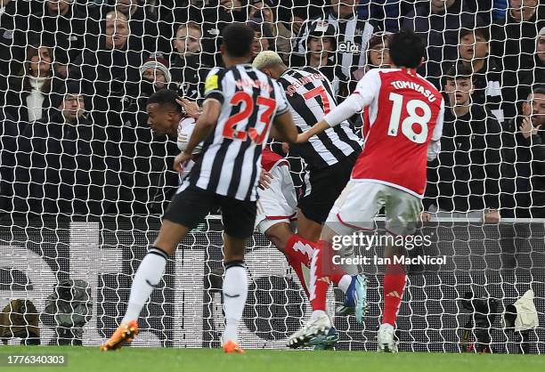 Gabriel of Arsenal is challenged by Jolinton of Newcastle United during the Premier League match between Newcastle United and Arsenal FC at St. James...