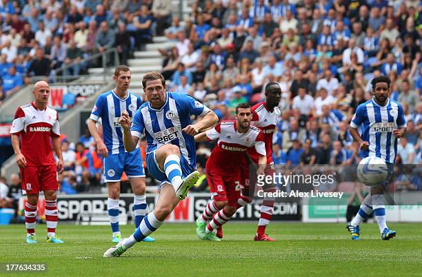 Grant Holt of Wigan Athletic scores the opening goal from the penalty spot during the Sky Bet Championship match between Wigan Athletic and...