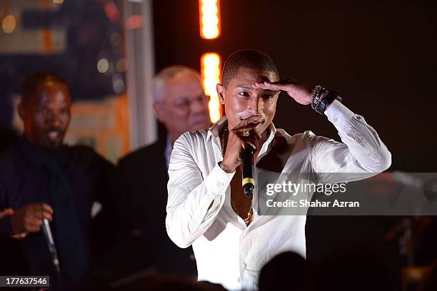 Pharrell performs at the 4th Annual Apollo In The Hamptons Benefit on August 24, 2013 in East Hampton, New York.