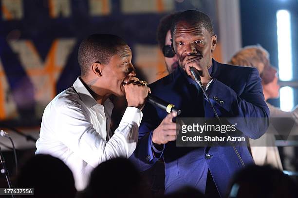 Pharrel and Jamie Foxx perform at the 4th Annual Apollo In The Hamptons Benefit on August 24, 2013 in East Hampton, New York.