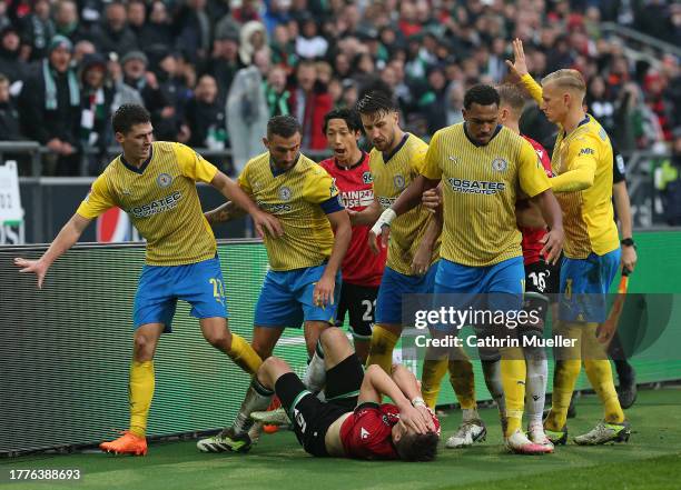 Fabian Kunze of Hannover 96 lies on the ground after a tussle with Ermin Bicakcic of Eintracht Braunschweig during the Second Bundesliga match...