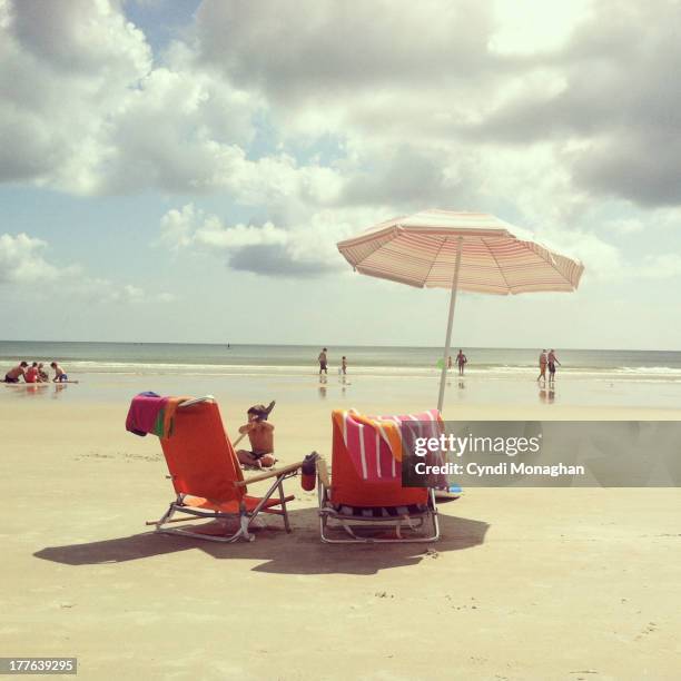 beach umbrella - beach umbrella sand stock pictures, royalty-free photos & images