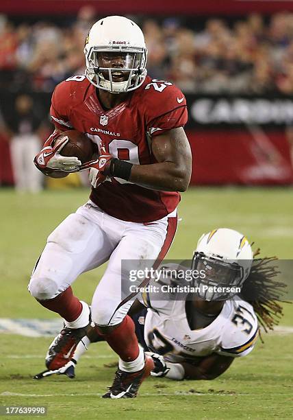 Running back Alfonso Smith of the Arizona Cardinals runs with the football after a reception past defensive back Jahleel Addae of the San Diego...