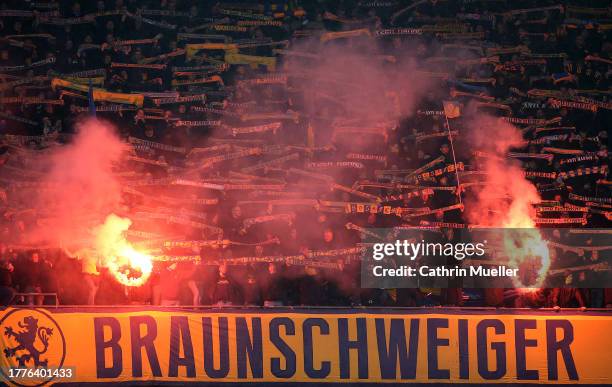 Fans of Eintracht Braunschweig burn flares during the Second Bundesliga match between Hannover 96 and Eintracht Braunschweig at Heinz von Heiden...