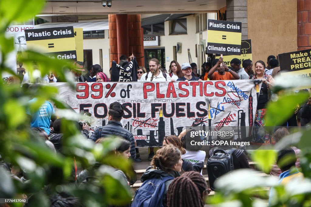 Activists from different parts of the world hold a banner...