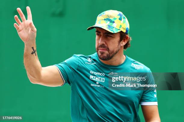 Fernando Alonso of Spain and Aston Martin F1 Team waves to the crowd on the drivers parade prior to the F1 Grand Prix of Brazil at Autodromo Jose...