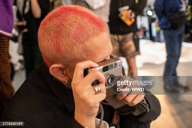 Fashion blogger with a Contax T2 film camera, a hot accessory at Labelhood, Shanghai Fashion Week Spring/Summer.