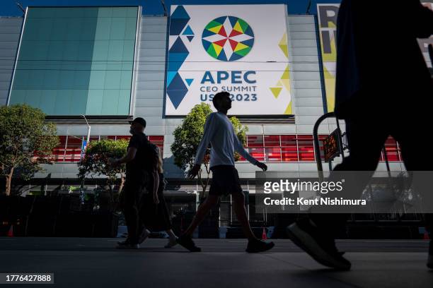People walk outside the Moscone Center during the Asia-Pacific Economic Cooperation meetings on November 11, 2023 in San Francisco, California. The...