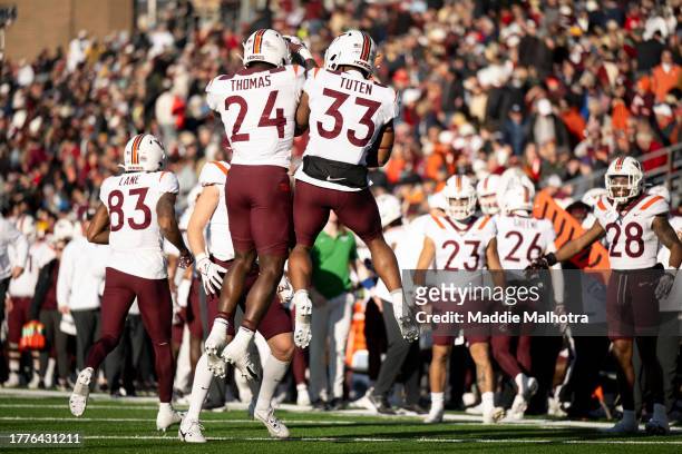 Malachi Thomas of the Virginia Tech Hokies reacts with Bhayshul Tuten of the Virginia Tech Hokies after a touchdown during the second half against...