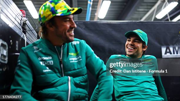 Lance Stroll of Canada and Aston Martin F1 Team and Fernando Alonso of Spain and Aston Martin F1 Team talk on the drivers parade prior to the F1...