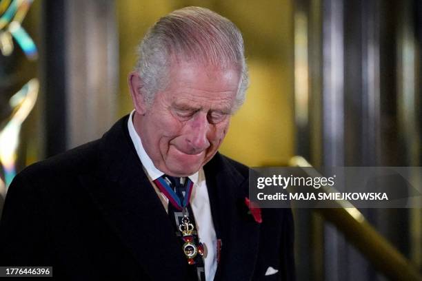 Britain's King Charles III reacts after unveiling statues of late Britain's Queen Elizabeth II and late Britain's Prince Phillip upon his arrival to...