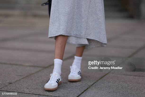 Jill Asemota seen wearing Dorothee Schumacher grey wool knit long dress, matching Dorothee Schumacher grey wool knit cardigan jacket, white cotton...