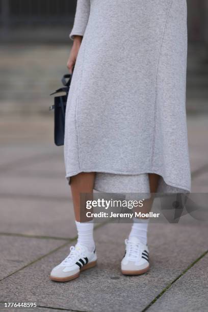 Jill Asemota seen wearing Dorothee Schumacher grey wool knit long dress, matching Dorothee Schumacher grey wool knit cardigan jacket, white cotton...