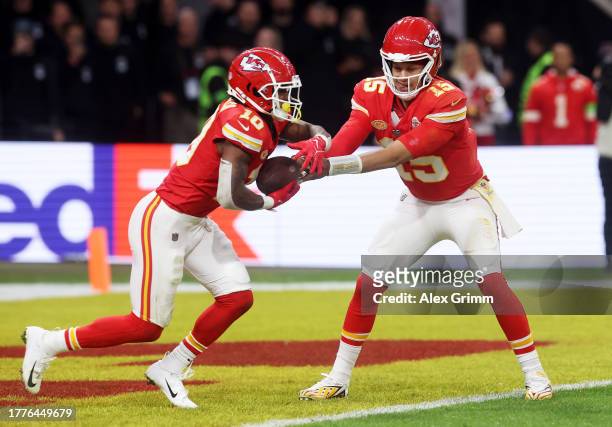 Patrick Mahomes of the Kansas City Chiefs hands off to Isiah Pacheco of the Kansas City Chiefs in the second quarter during the NFL match between...