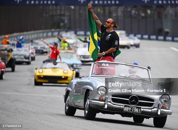 Lewis Hamilton of Great Britain and Mercedes waves to the crowd on the drivers parade prior to the F1 Grand Prix of Brazil at Autodromo Jose Carlos...