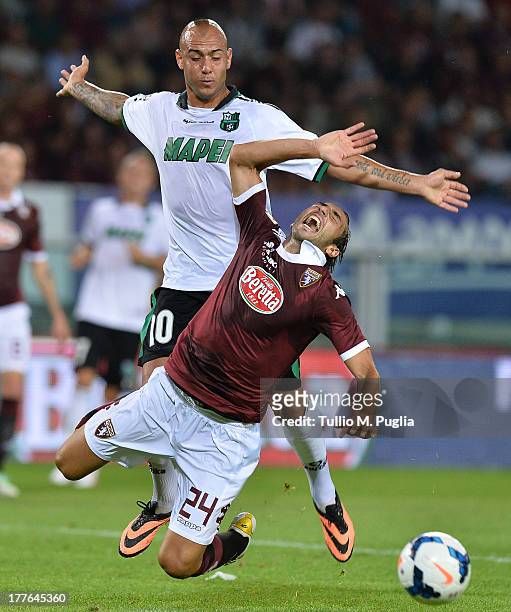 Emiliano Moretti of Torino and Simone Zaza of Sassuolo compete for the ball during the Serie A match between Torino FC and US Sassuolo Calcio at...