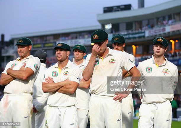 Ryan Harris, David Warner and James Faulkner of Australia look dejected after day five of the 5th Investec Ashes Test match between England and...