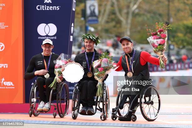 Silver medalist Daniel Romanchuk of the United States, gold medalist Marcel Hug of Switzerland and bronze medalist Jetze Plat of the Netherlands pose...