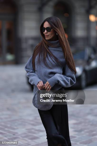 Jill Asemota seen wearing Jacques Marie Mage black sunglasses, Dorothee Schumacher grey wool knit sweater, Dorothee Schumacher black silk midi skirt,...