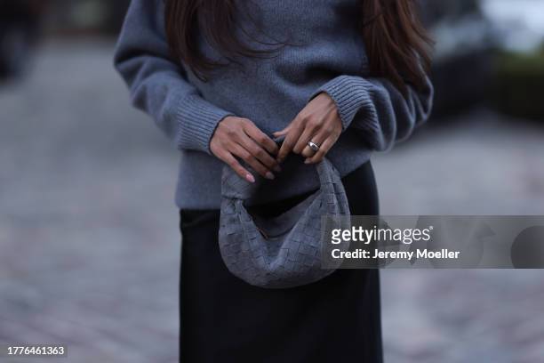 Jill Asemota seen wearing Dorothee Schumacher grey wool knit sweater, Dorothee Schumacher black silk midi skirt, Bottega Veneta grey suede leather...