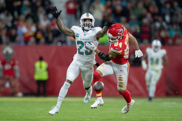 Xavien Howard of Miami Dolphins and Justin Watson of Kansas City Chiefs battle for the ball during the NFL match between Miami Dolphins and Kansas...