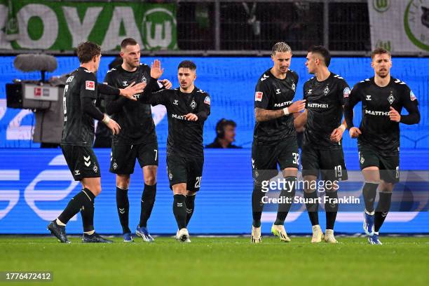Rafael Santos Borre of Werder Bremen celebrates with teammates after scoring the team's second goal during the Bundesliga match between VfL Wolfsburg...