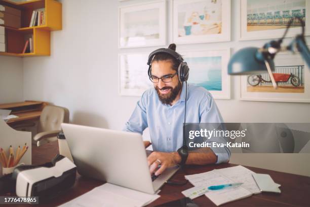 young man working at home - stockbrokers stock pictures, royalty-free photos & images