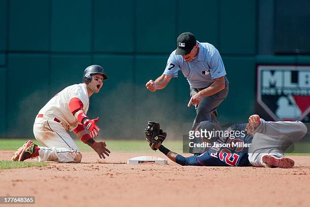 Nick Swisher of the Cleveland Indians reacts as he is called out by second base umpire John Hirschbeck as shortstop Pedro Florimon of the Minnesota...