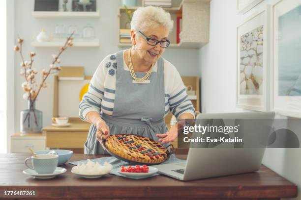 senior woman at home - cherry pie stock pictures, royalty-free photos & images