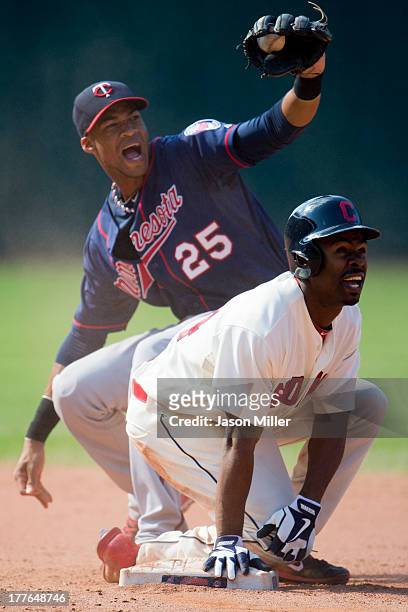 Shortstop Pedro Florimon of the Minnesota Twins reacts as Michael Bourn of the Cleveland Indians is called safe after stretching a double off a fly...